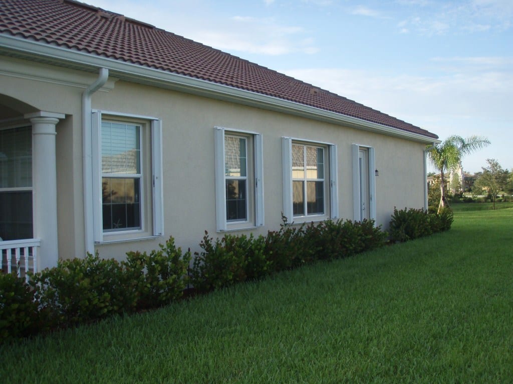 accordion shutters on a South Florida home's windows for hurricane and storm protection