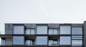 Home equipped with hurricane panels protecting windows from strong winds and storm debris.