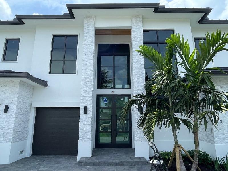Impact windows and entry doors installed on a modern two-story Florida home