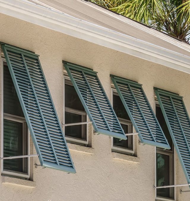 Light-Yellow-House-with-blue-green-Bahama-Shutters