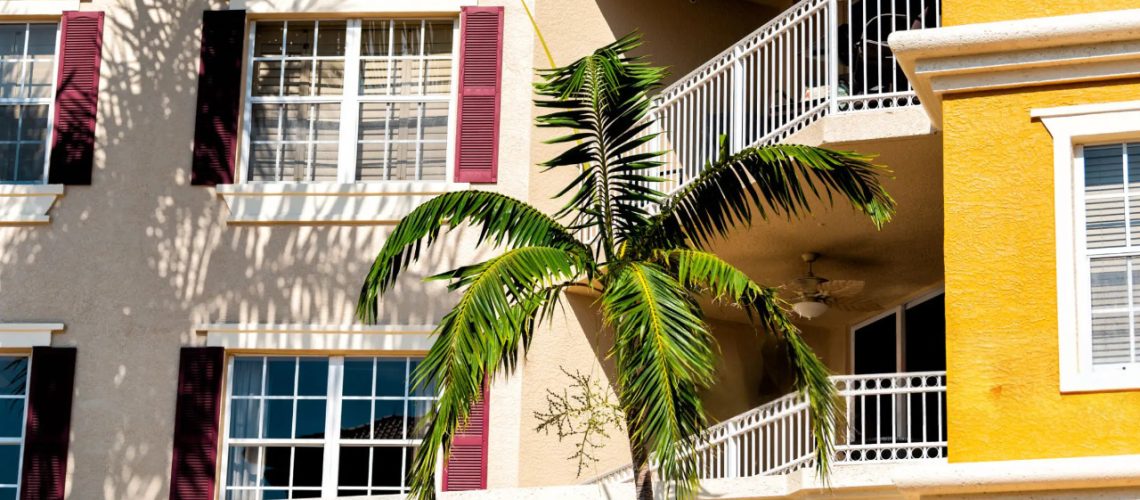 Installer fitting premium impact-resistant windows in Naples FL